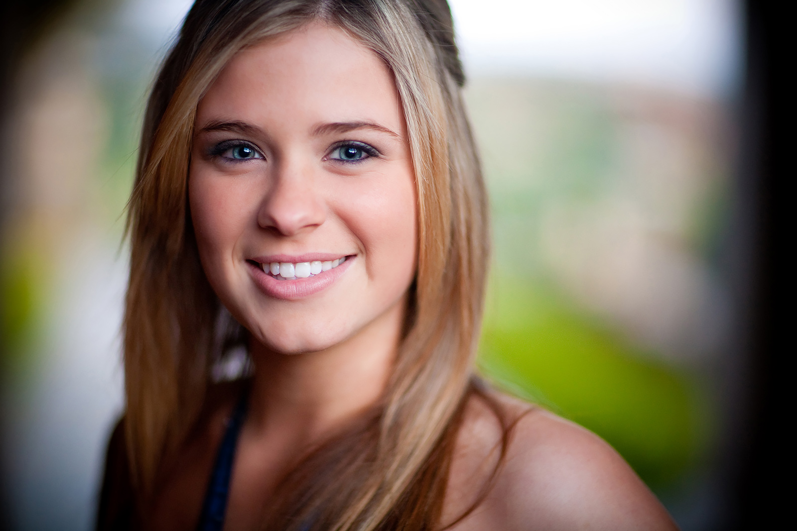Color headshot portrait of blonde teenage girl smiling
