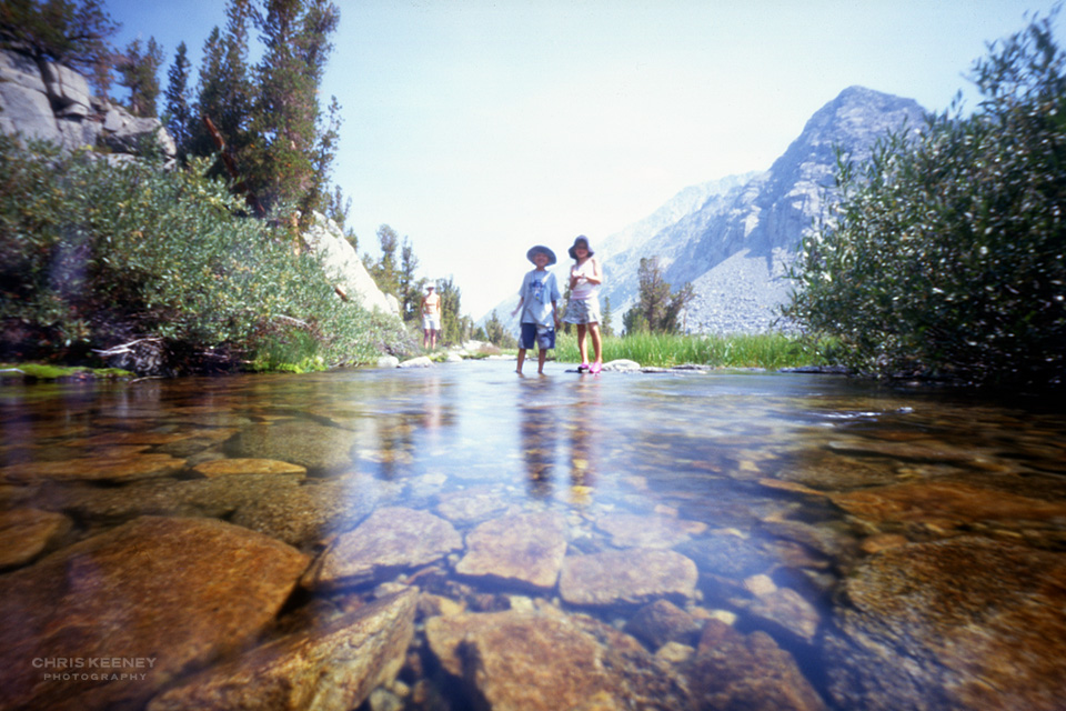 Color 6x7 ZeroImage pinhole photograph of my son and daughter standing in a mountain stream in the Eastern Sierras in California