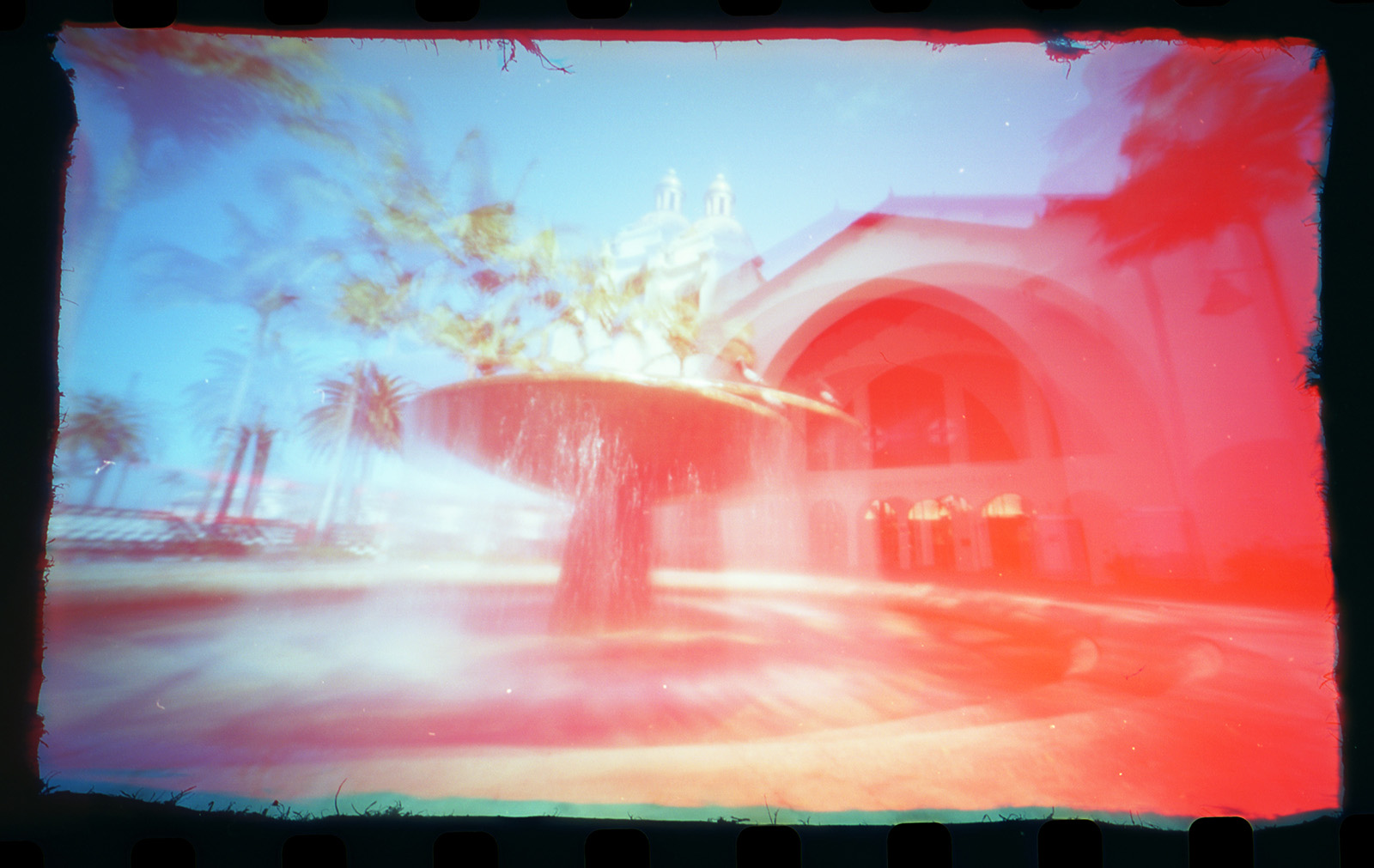 Color 35mm film photograph created with a homemade matchbox pinhole camera of the train depot in downtown San Diego California