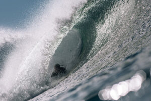 Chris Keeney bodysurfing a wave and getting barreled at Blacks Beach in La Jolla