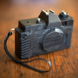 Cheap plastic 35mm film camera bought at a thrift store, the lens taken off and turned into a pinhole camera