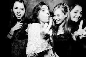 Black and white high contrast photo of teens having some fin at a birthday party
