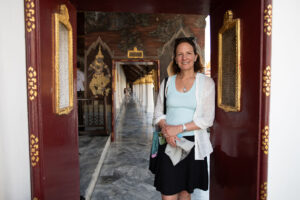 horizontal portrait of my wife standing in the doorway of a hallway at the Grand Palace in Bangkok, Thailand