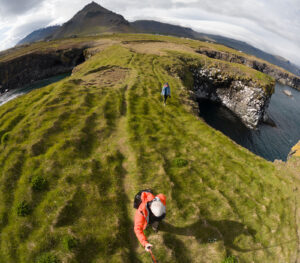 Chris walking with his wife along the grassy bluffs of The Snæfellsnes Peninsula in Iceland