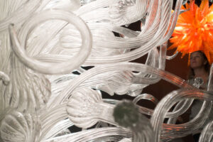 A woman looking up at some glass artwork created by the artist Dale Chihuly at the Chihuly Garden and Glass in Seattle Washington