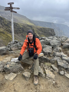 Chris Keeney sitting down and taking a rest stop while hiking the Fimmvörðuháls Trail in Þórsmörk Iceland 2024