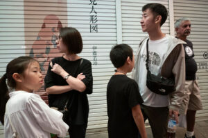 A photo of people looking in all different directions at the Nishiki Market in downtown Kyoto Japan