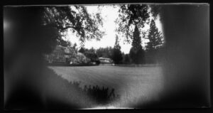 black and white photograph of the Meadowood Hotel in Napa valley. You can see a large lawn in front of a large English style architecture building