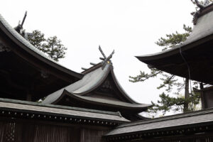 a photo of the curved rooflines of the Aso Jinja Shinto shrine in Japan