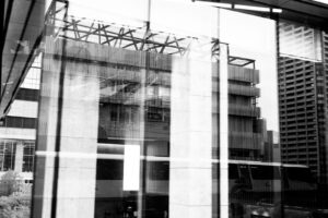 black and white abstract photography of reflections in the windows as the train passes by in Tokyo Japan