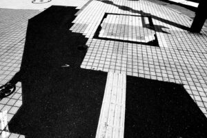 black and white abstract photography of white sidewalk tiles mixed with black asphalt in Hachinohe, Japan