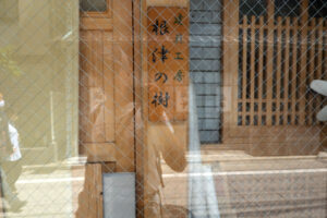 a reflection of Chris Keeney with his camera in Tokyo Japan
