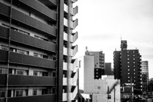 black and white photograph of buildings seen from the window of the Shinkansen High Speed Bullet Train in Japan