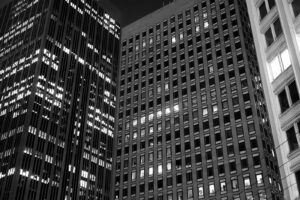 Black and white nighttime photograph of skyscrapers in downtown San Francisco, California with some lights on and others off creating an interesting digital pattern of light and dark