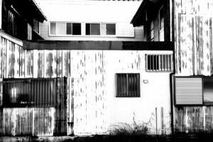 Black and white monochrome photograph of building and windows in the city of Nachikatsuura Japan