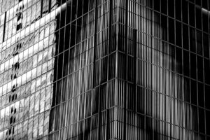 Black and white high contrast photography of the windows of a skyscraper in the Shibuya district (Shibuya-ku). Vertical and horizontal black and white line intersect in an interesting geometric pattern. Tokyo, Japan